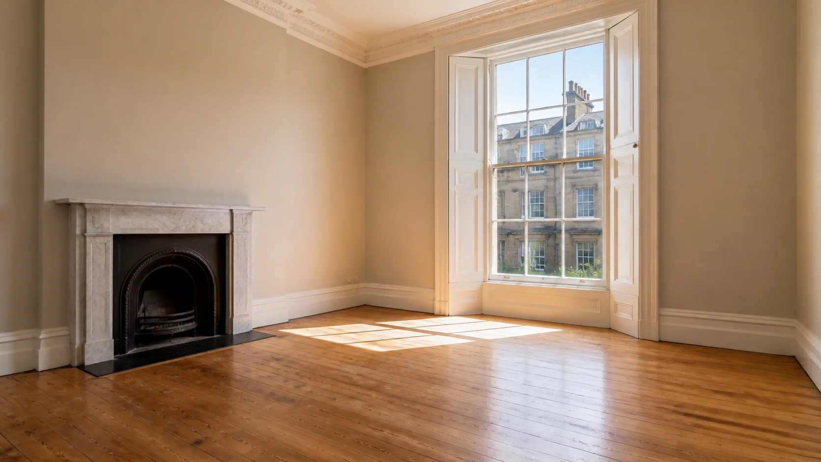 An empty period reception room with original shutters